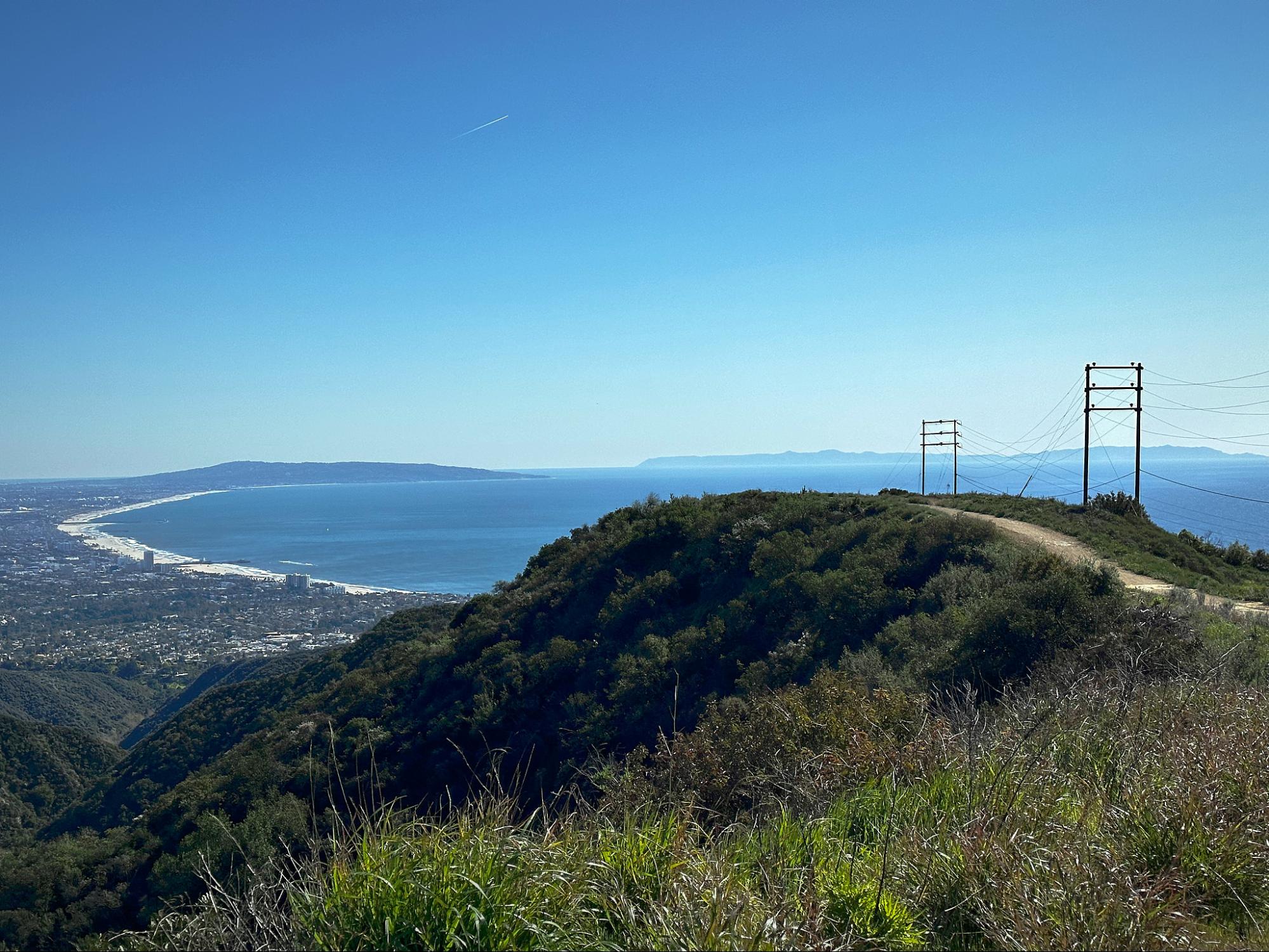 a view of a hill with power lines on top of it