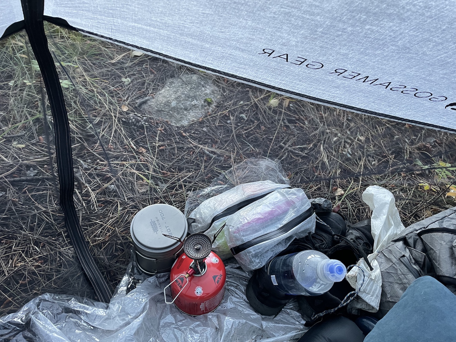 an open umbrella sitting on top of a pile of trash