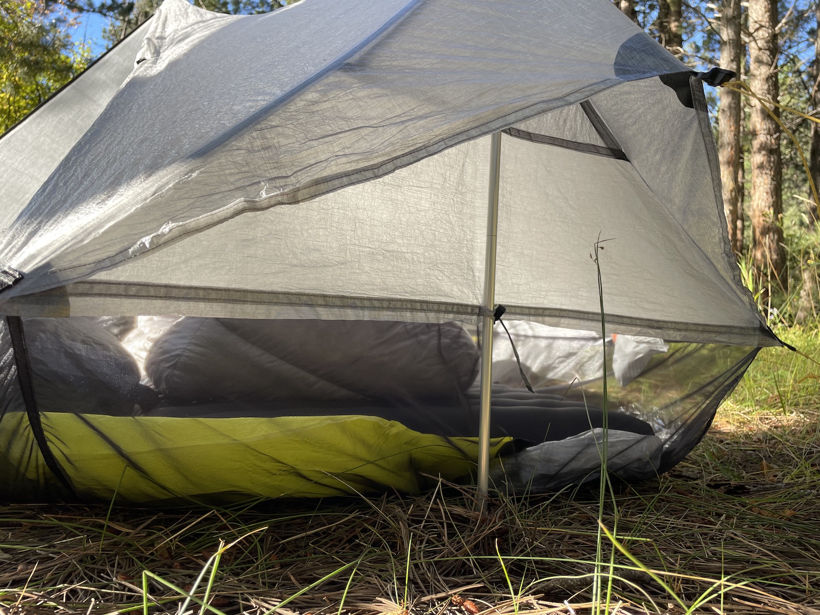 a tent sitting in the middle of a forest