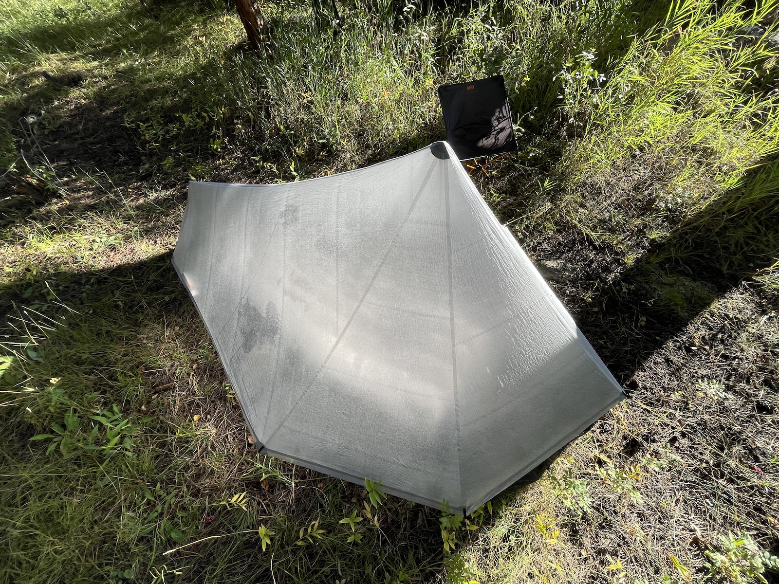 an upside down umbrella sitting in the grass