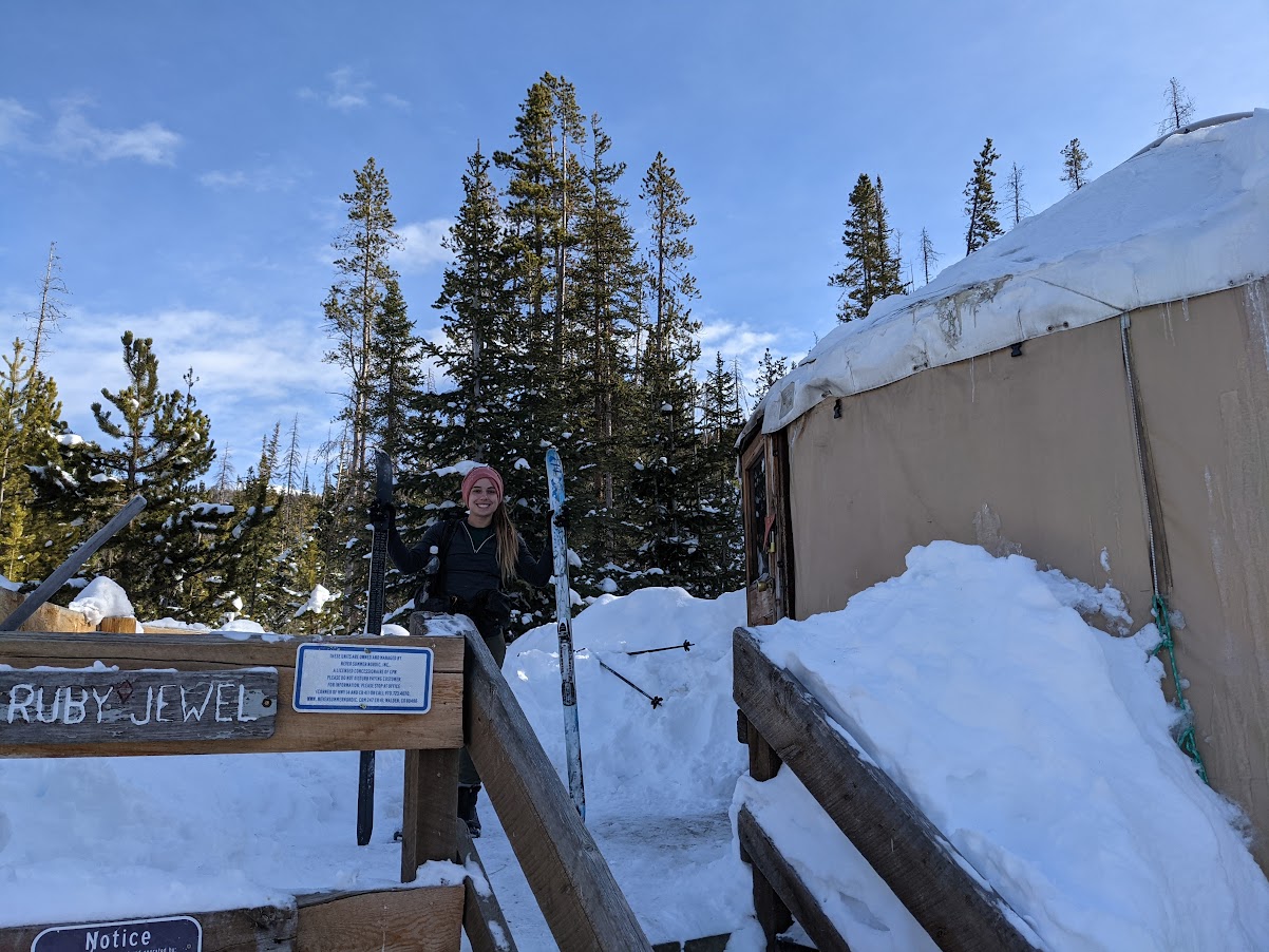 a woman standing on a snow covered bridge