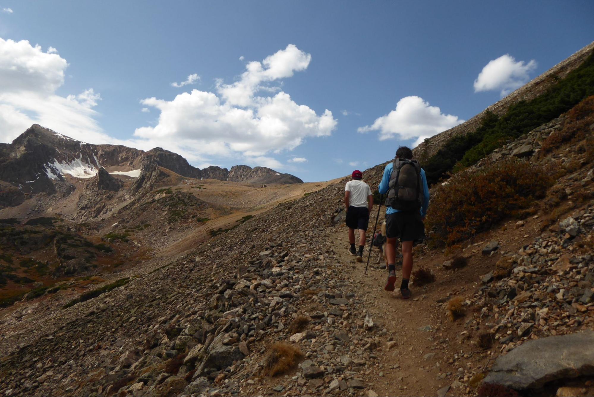 a couple of people that are walking down a hill