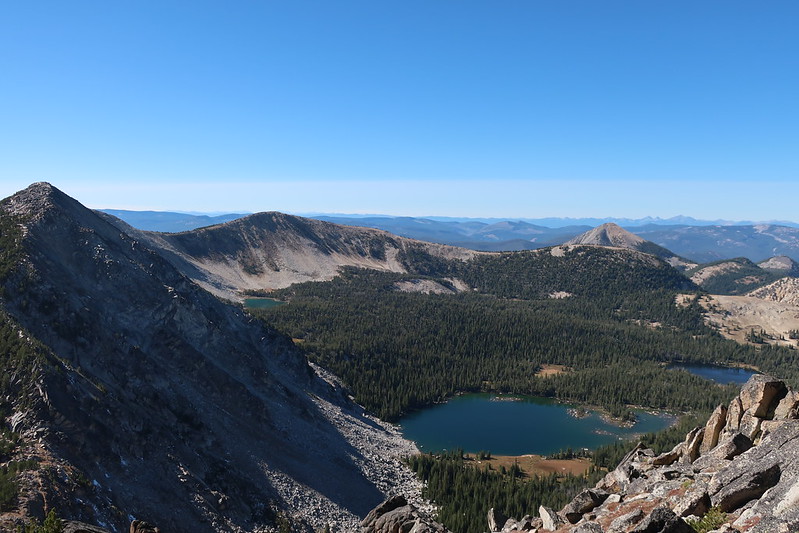 a view from the top of a mountain looking down at a lake