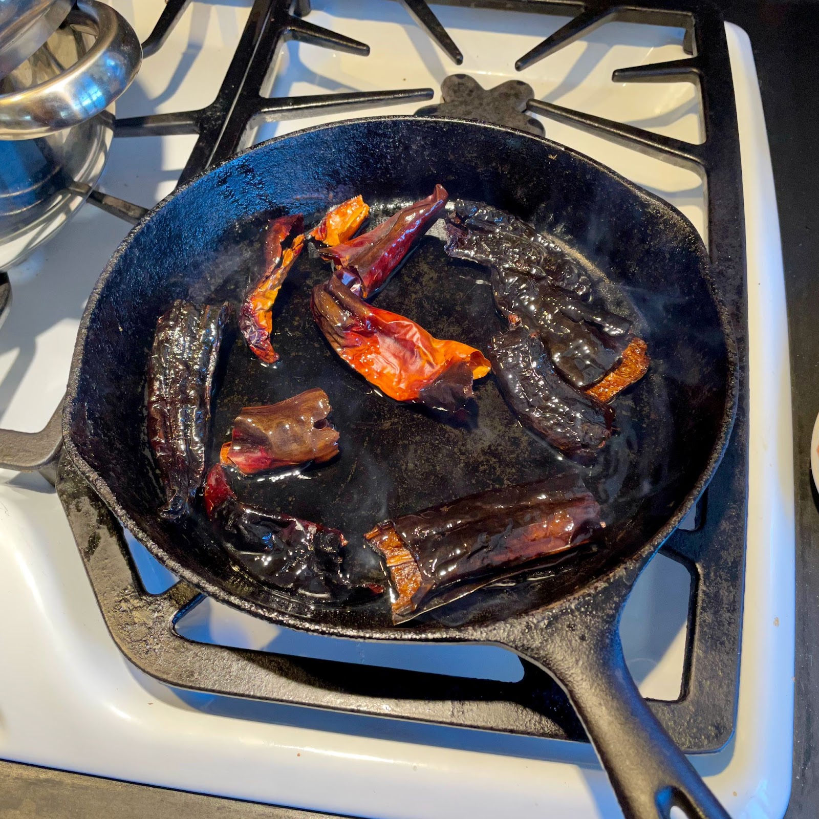 a skillet full of searing peppers 