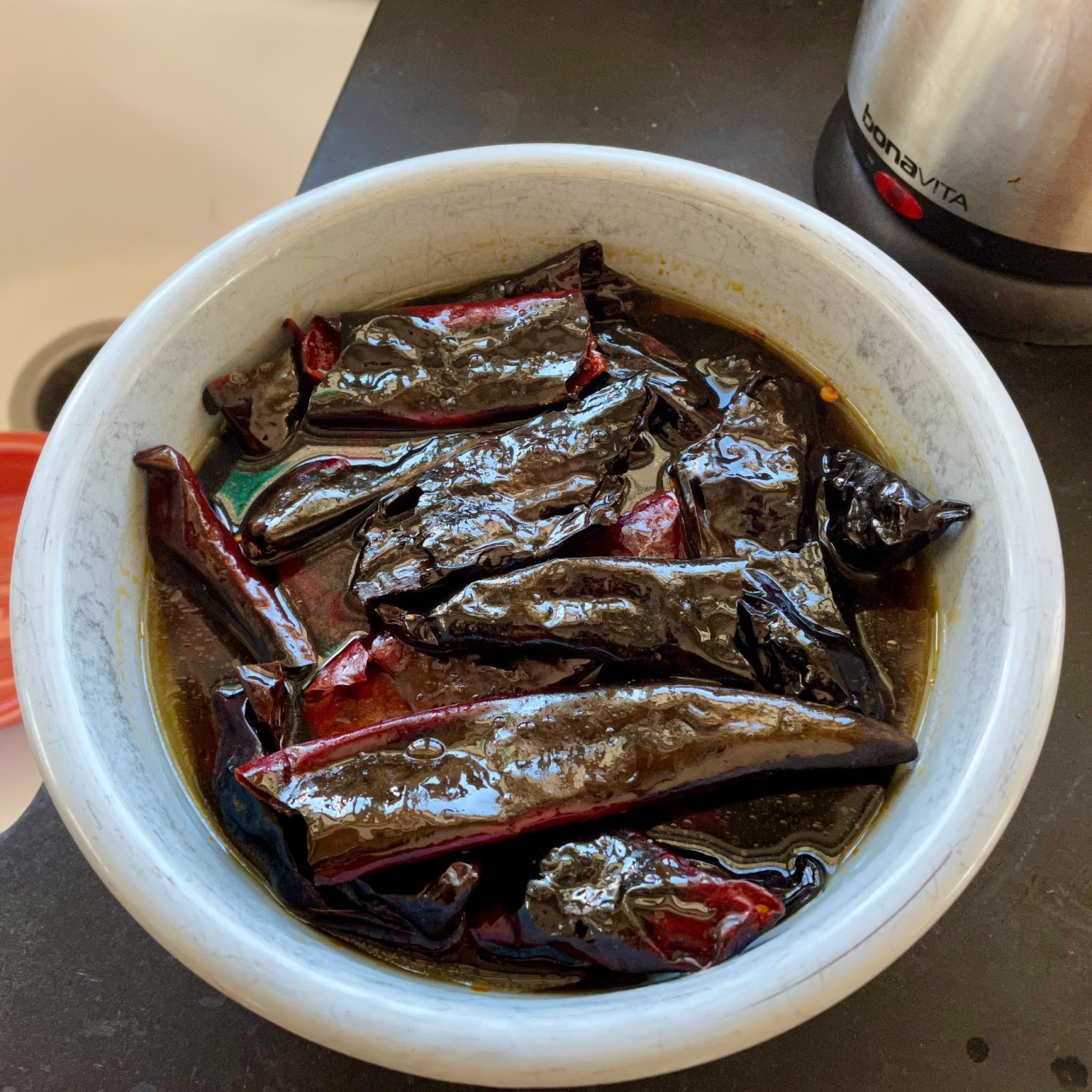 a bowl full of peppers soaking