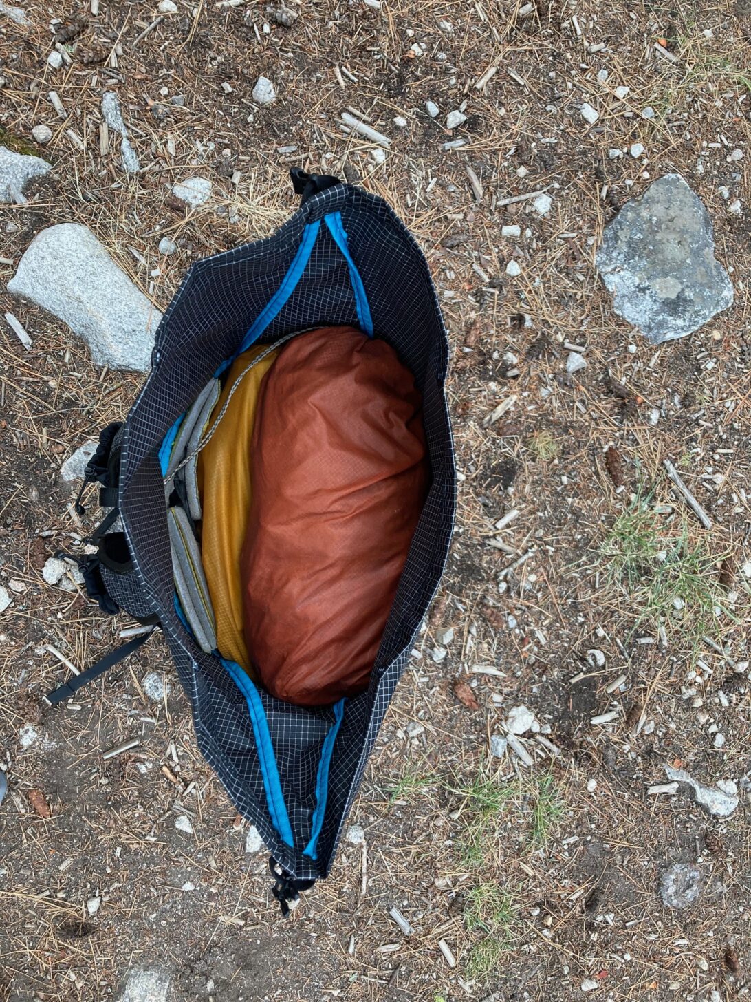 a shot from above looking down into a minimalist pack with gear visible.