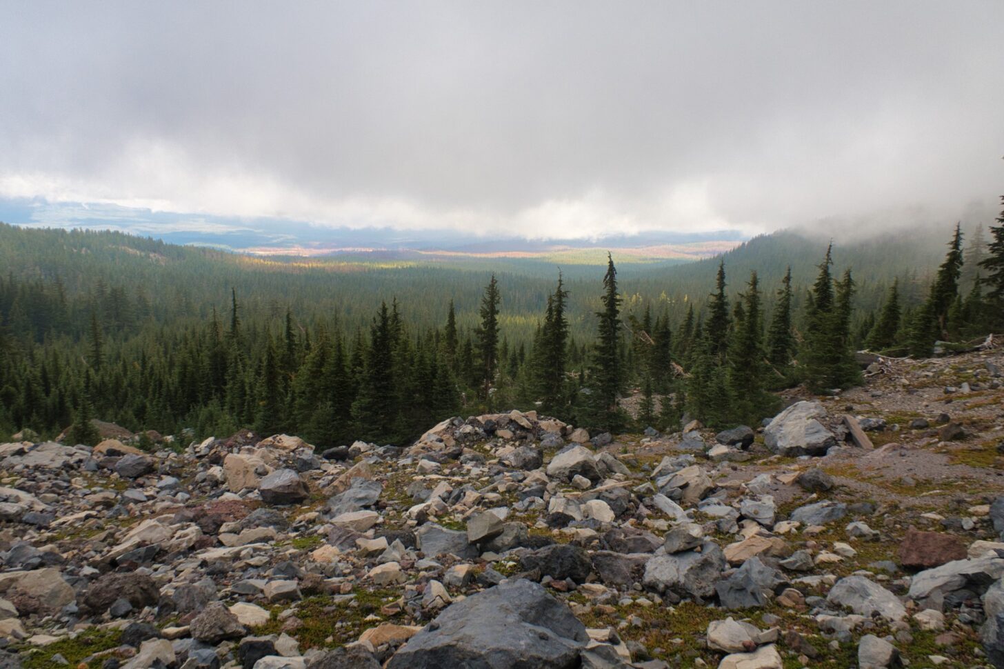 Fog rolls in over the mountains.