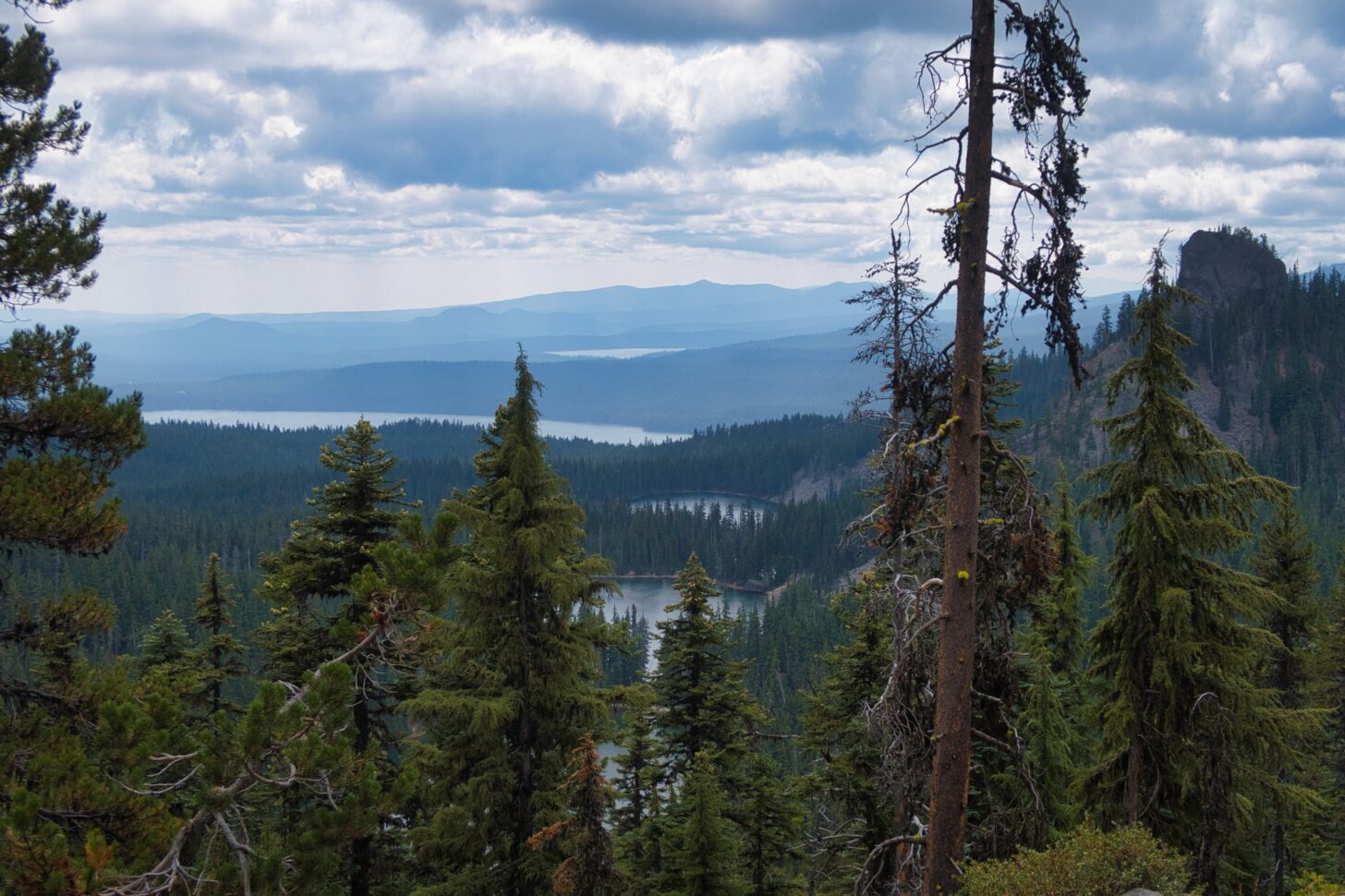 Looking down at a series of lakes from atop a high rigeline.