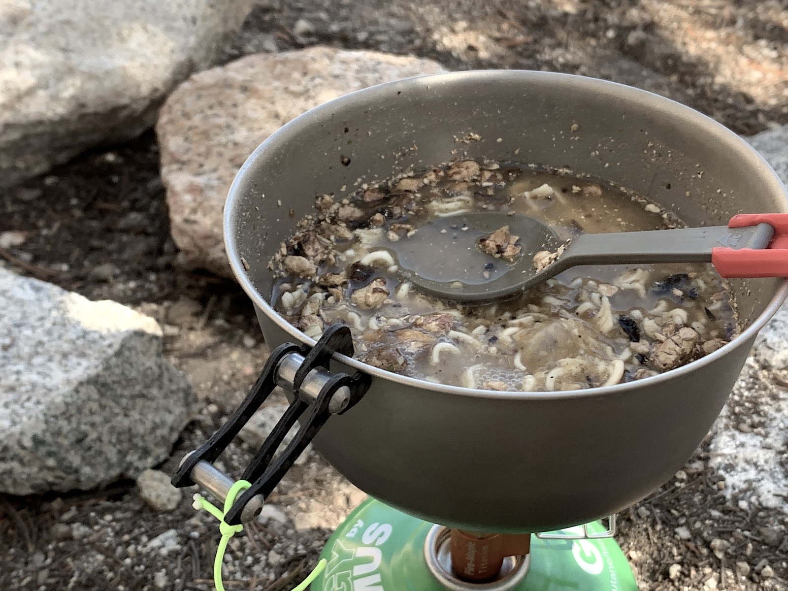 a pot filled with food sitting on top of a stove