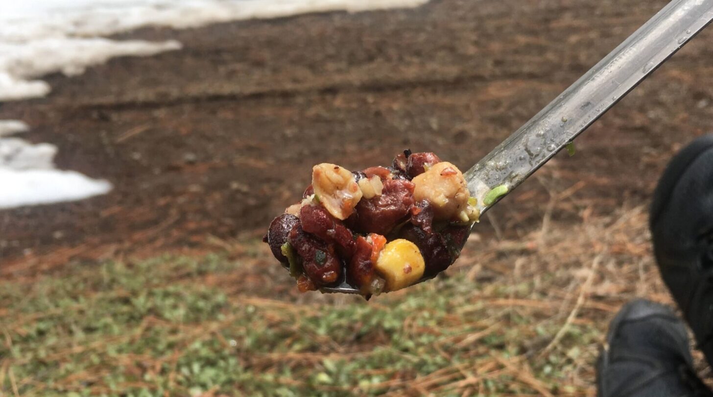 a close-up of a spoon loaded up with food.