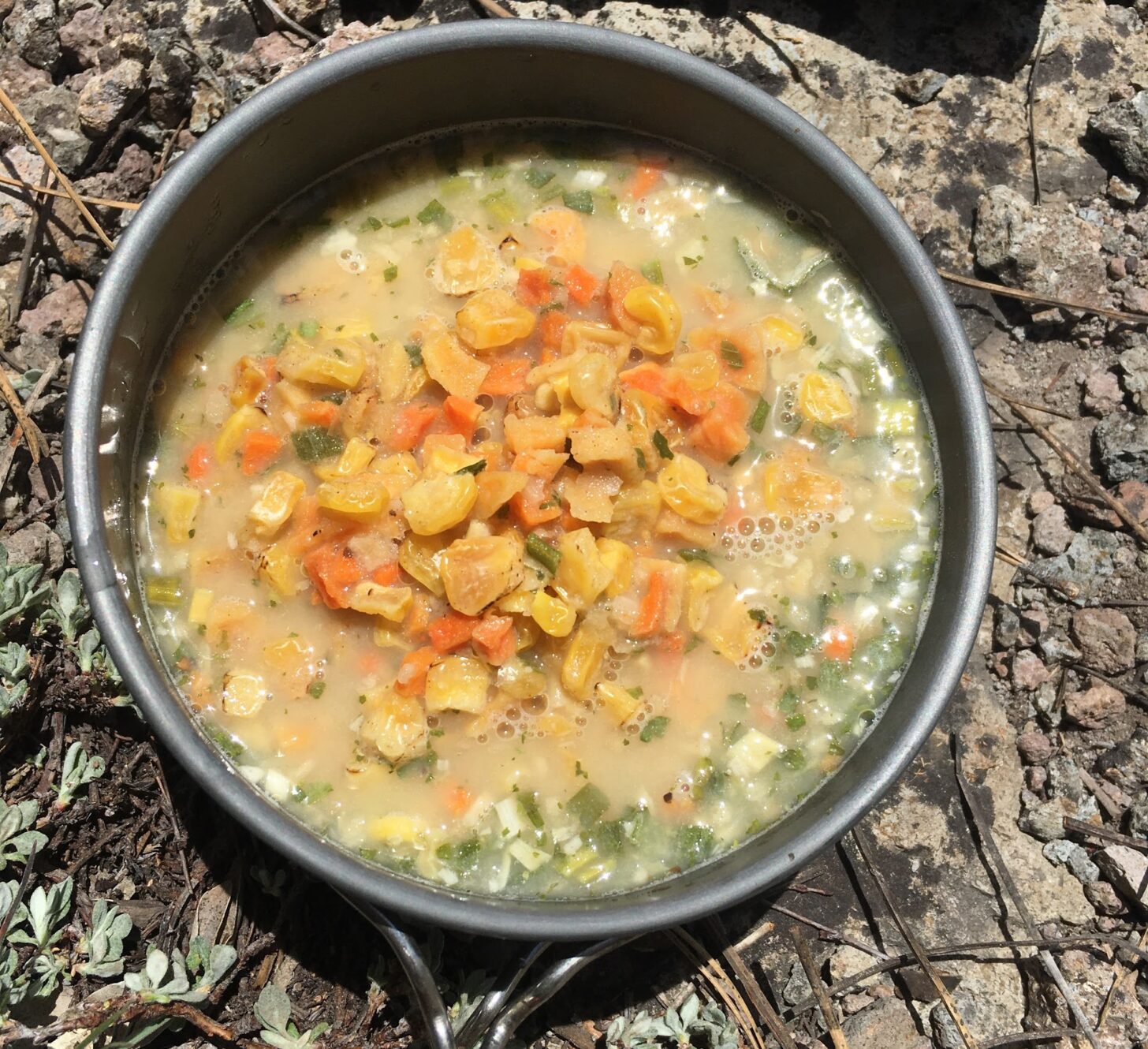 a wide, shallow pot filled with soup.