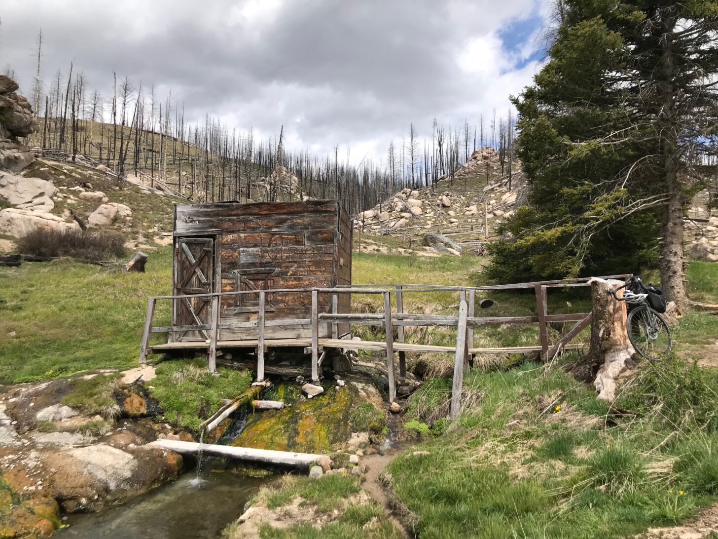 A small bathhouse is pictured at a hot springs.