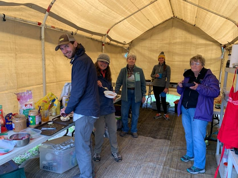 a group of people standing inside of a tent