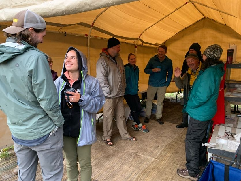 a group of people standing under a tent